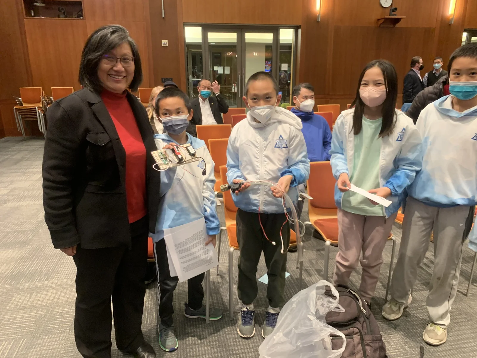 Liang Chao with students displaying hands-on science and engineering projects