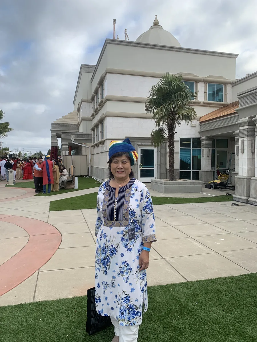 Liang Chao outside a Hindu temple during a community gathering